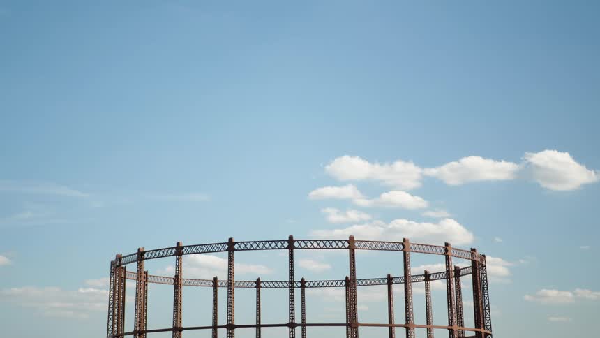Clouds move over a disused gas tower