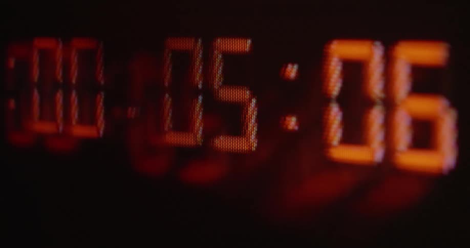 Close up numbers of digital stopwatch showing time running out in milliseconds on vintage screen with rgb pixels