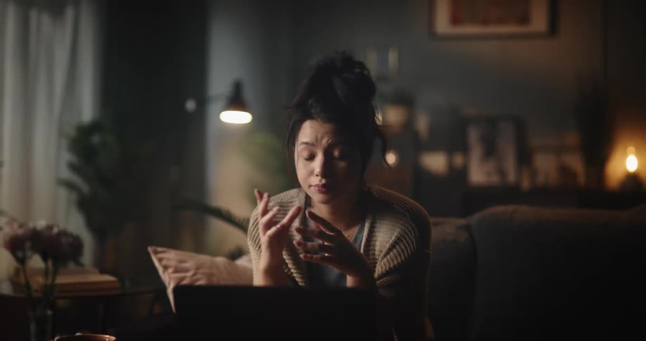 A woman looks at a laptop