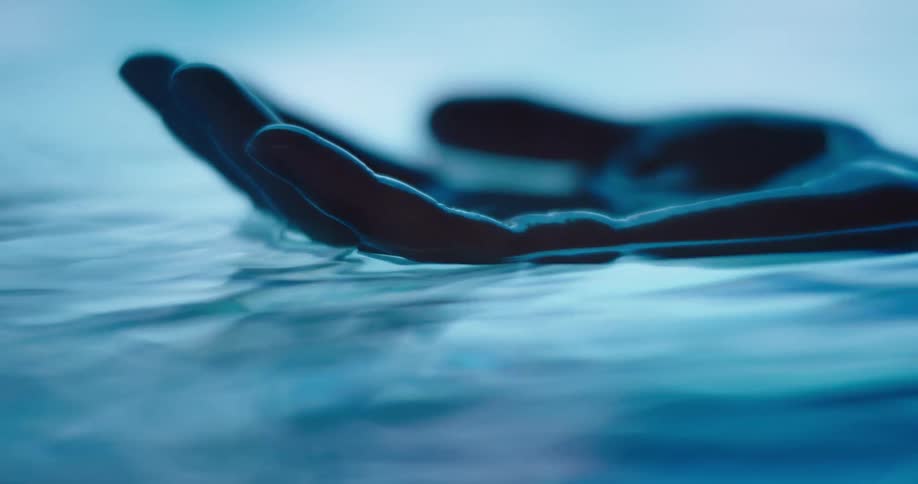 A hand is floating in the water