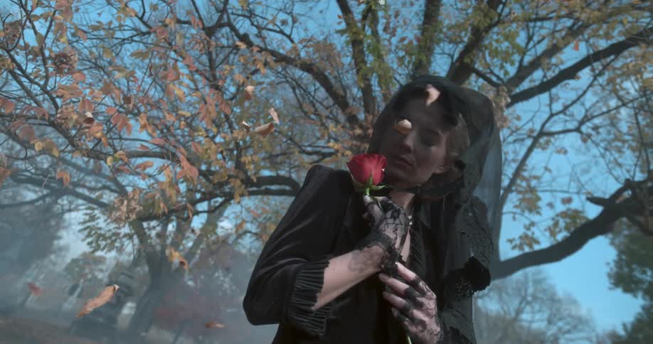 A woman is holding a rose