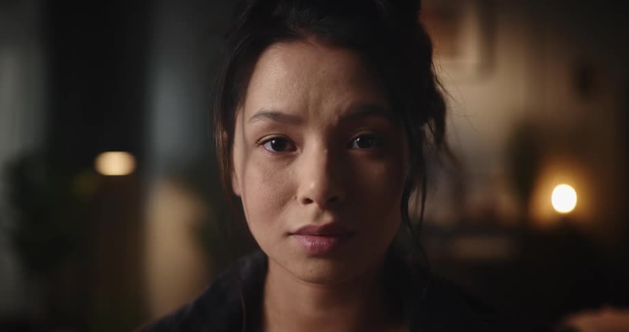 Woman stares directly in to the camera