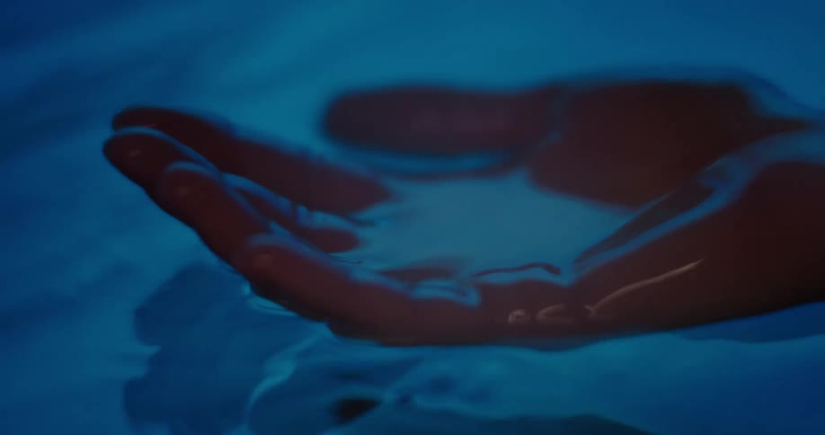 Womans cupped hand taking water