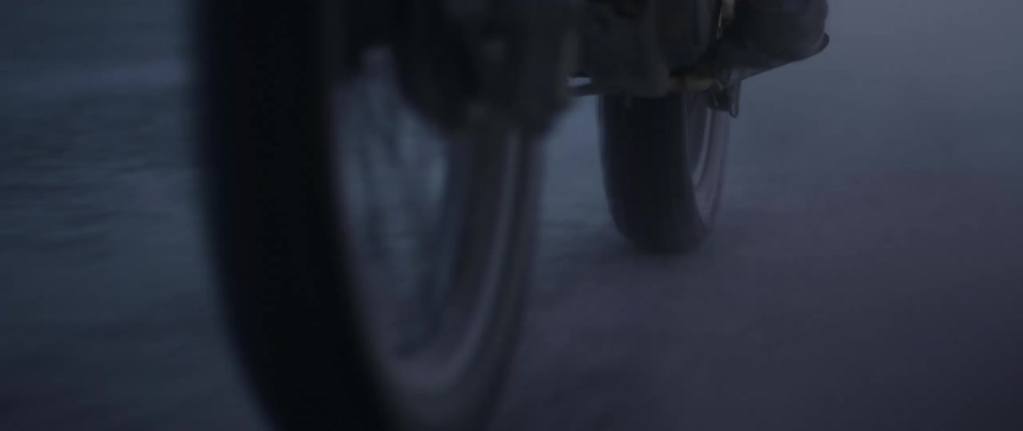 Person rides motorcycle on dirt road
