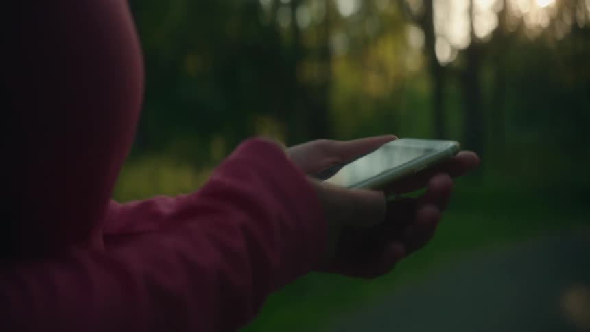 A woman holds up her phone