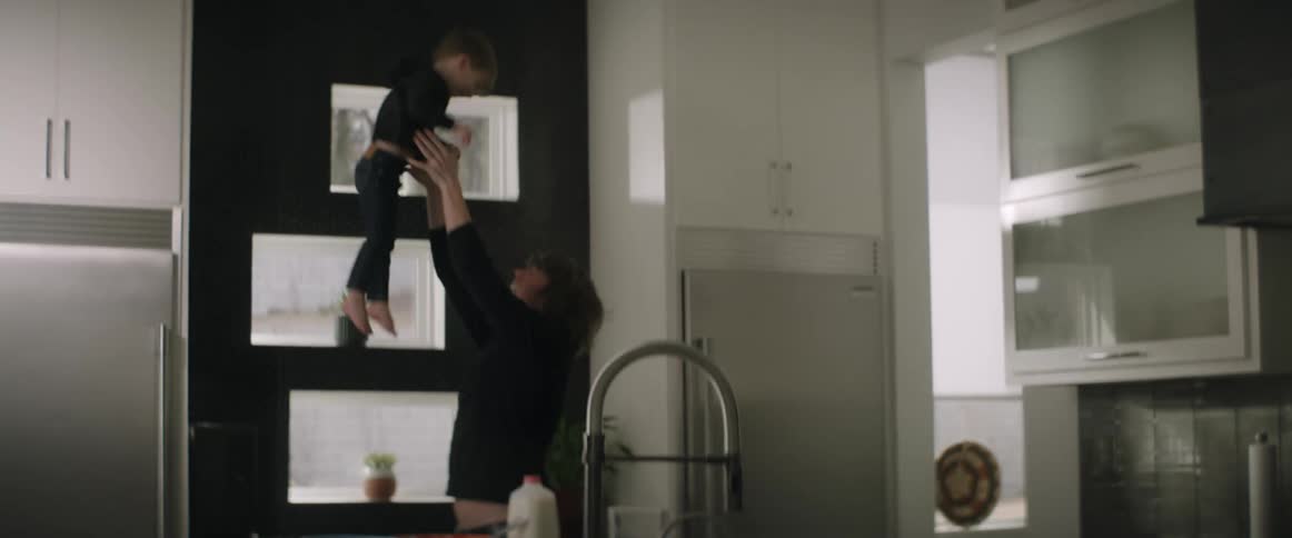 A father throws his son up and down into his arms