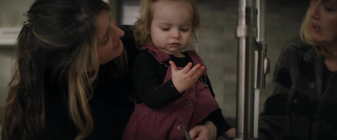 A mother and daughter at a kitchen sink