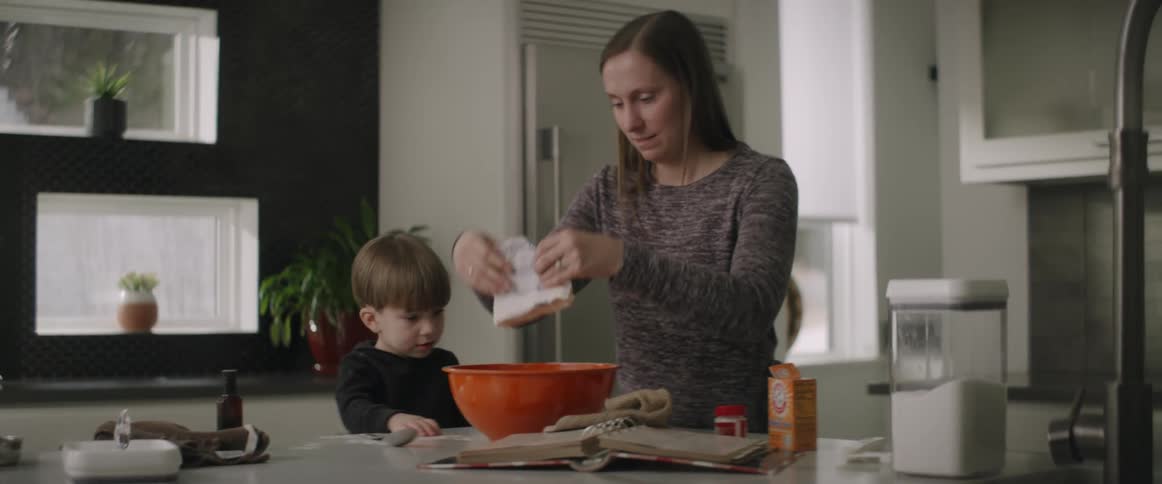 Mother and son cooking together in the kitchen at home