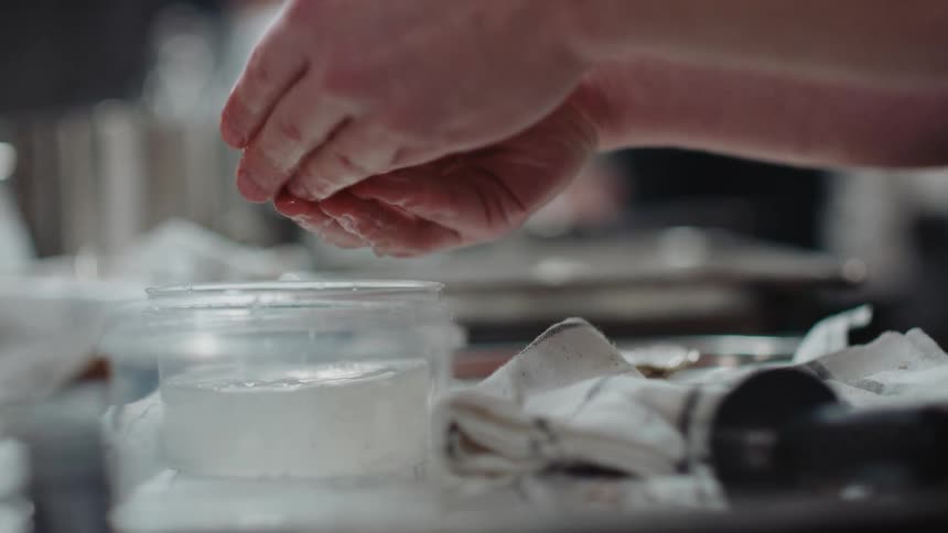 A person is shucking oysters