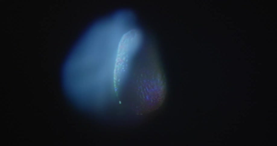 Macro shot of pixelated organic avocado half rotating with transformation on glitching vintage tube television