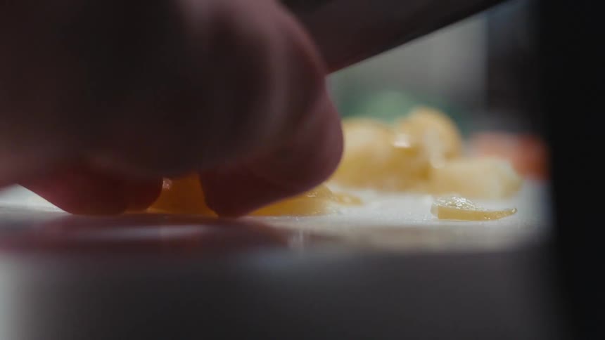 A person cutting up food with a knife