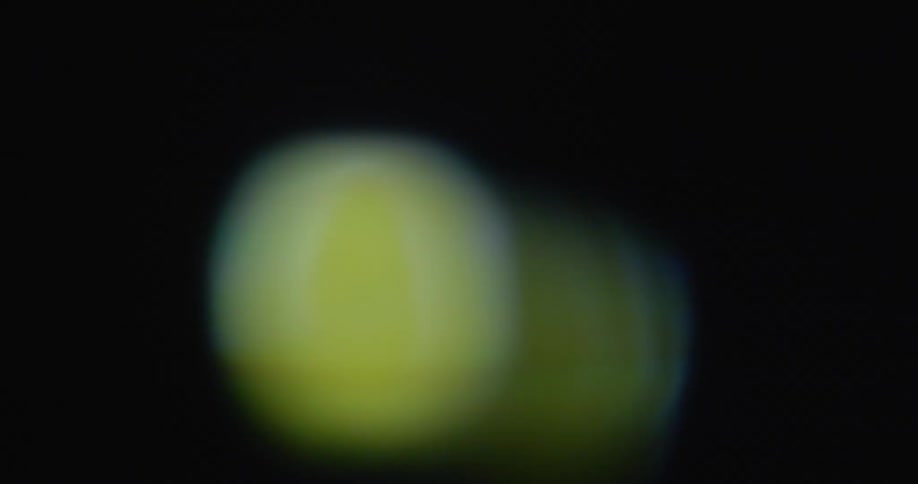 Animated orange slice spins around in space on old television screen with transformation