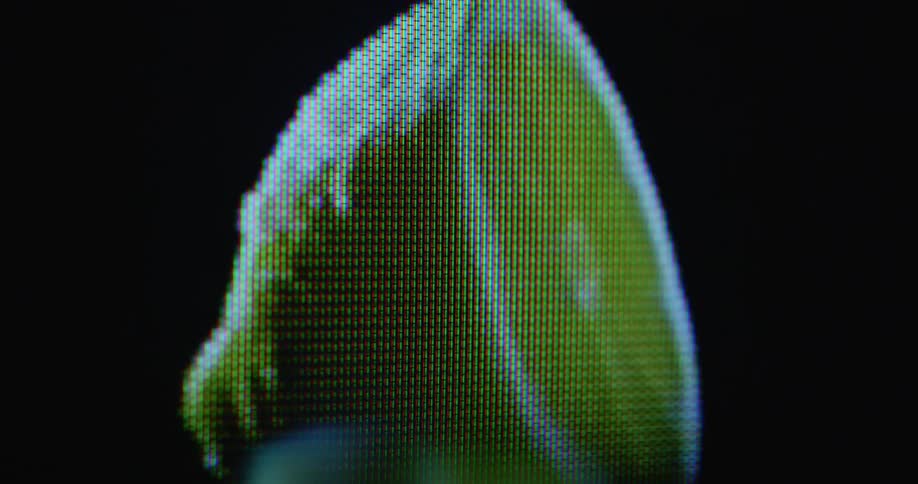 Surreal digitized image of half a lemon rotating on a pixelated vintage tube TV with glitches