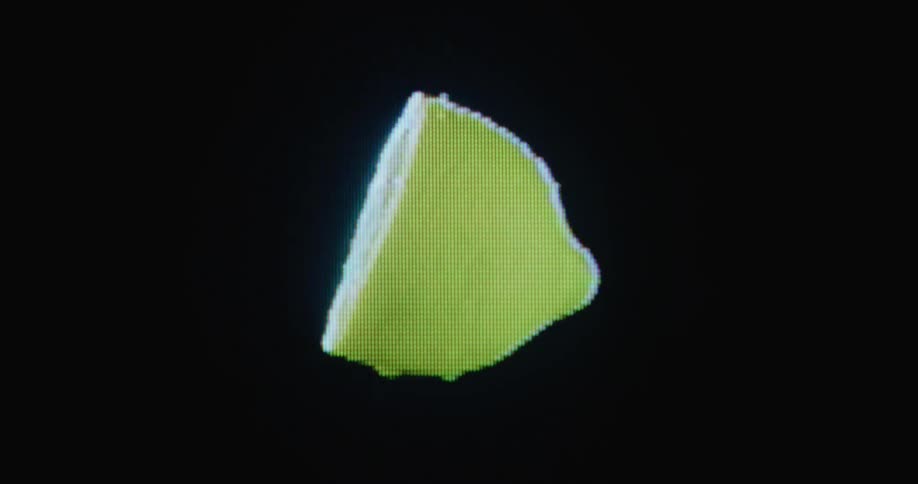 RGB pixels forming half of a lemon dripping juice and spinning with black background on glitching retro television screen