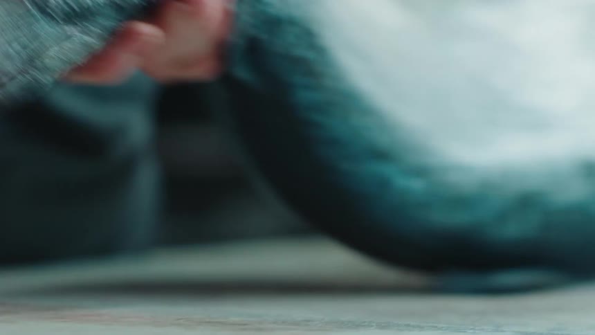 Close up of the hands of a chef using a sharp kitchen knife to slice and cut a fish