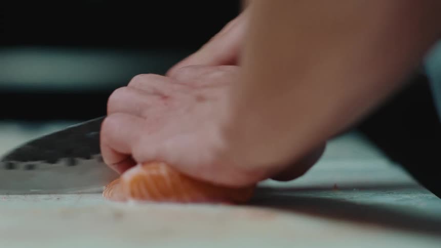 A person cutting some fish