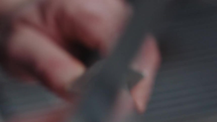 An up close view of a person sharpening a knife