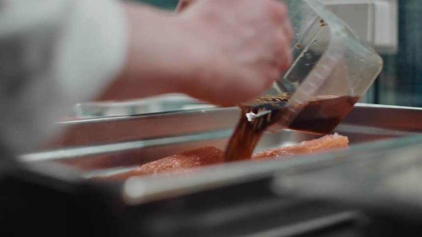 A chef is preparing a fish meal in a kitchen