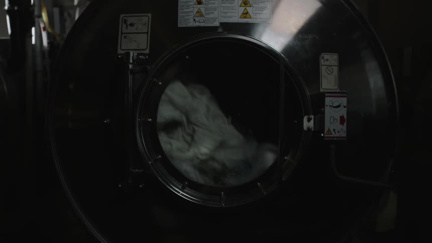 Laundry tumbles in an industrial washing machine