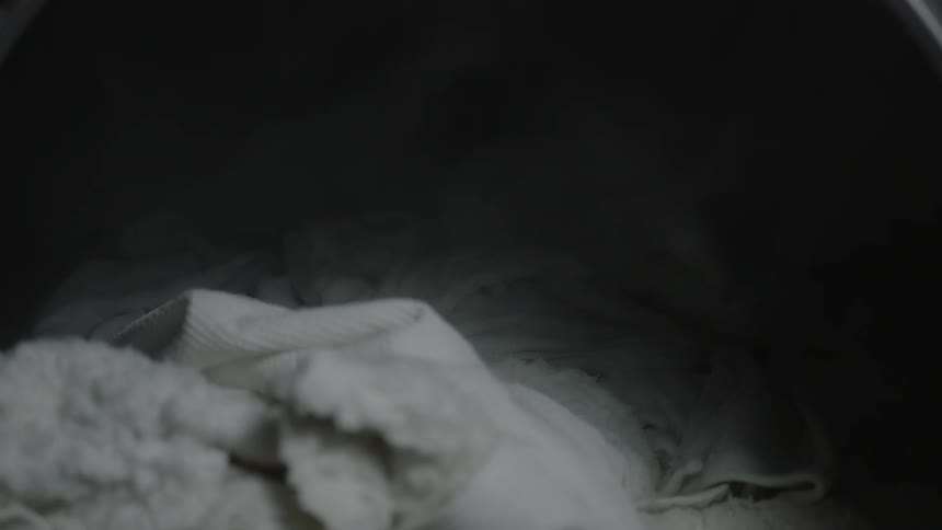 Laundry sits in an open washing machine