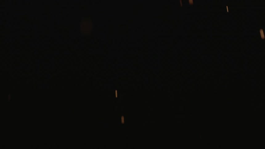 Sparks fall in a dark area