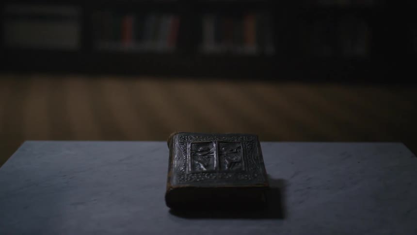 A book sits on a table in a library