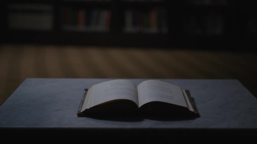 A book lays open on this table