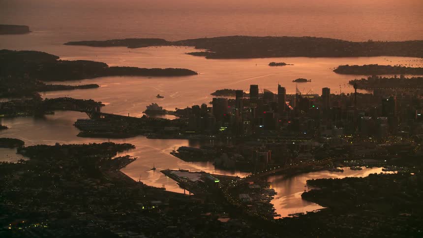 Aerial view of the city of sidney surrounded by rivers near the ocean at the sunset golden hour
