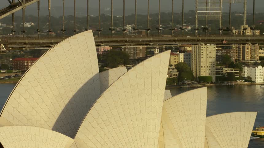 An aerial view of a large building and bridge in a city