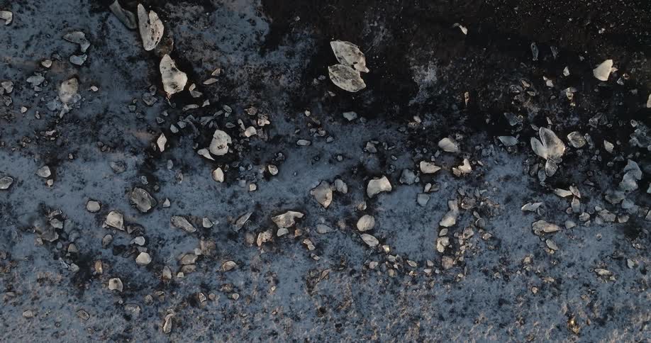 White pieces and chips cover ground they are strewn across