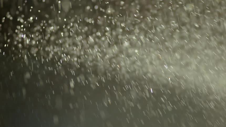 Precipitation fills air contrasting with pale gray background
