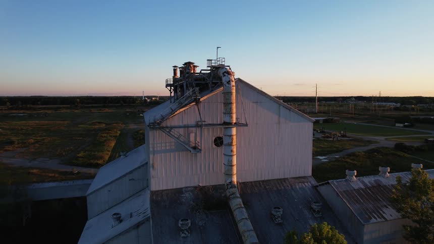 Aerial view of a factory building on the plains at evening
