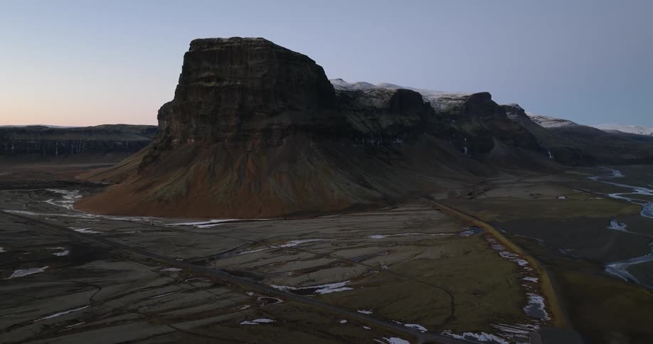A tall mountain fills the clear sky