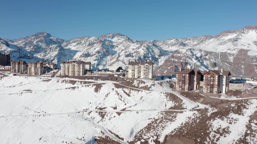 An aerial view of buildings on a snowy mountain range