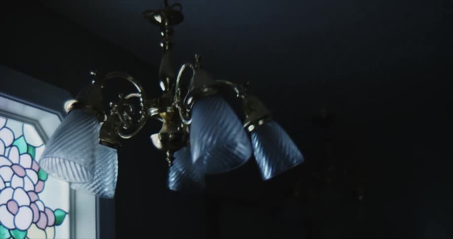 The chandelier is rocking back and forth