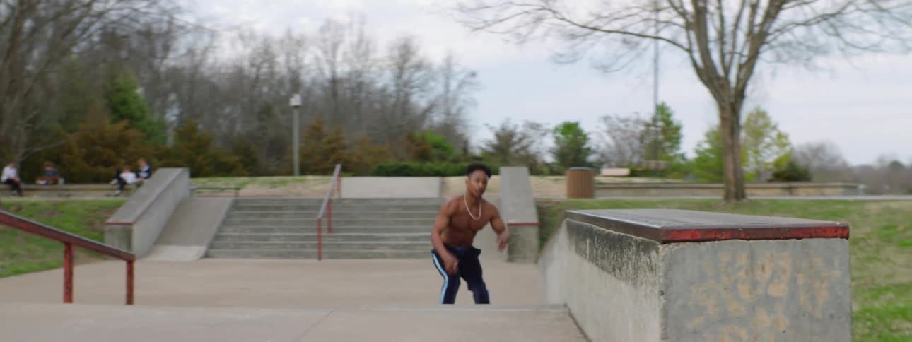 A man on roller skates riding down a ramp and then up on a wall