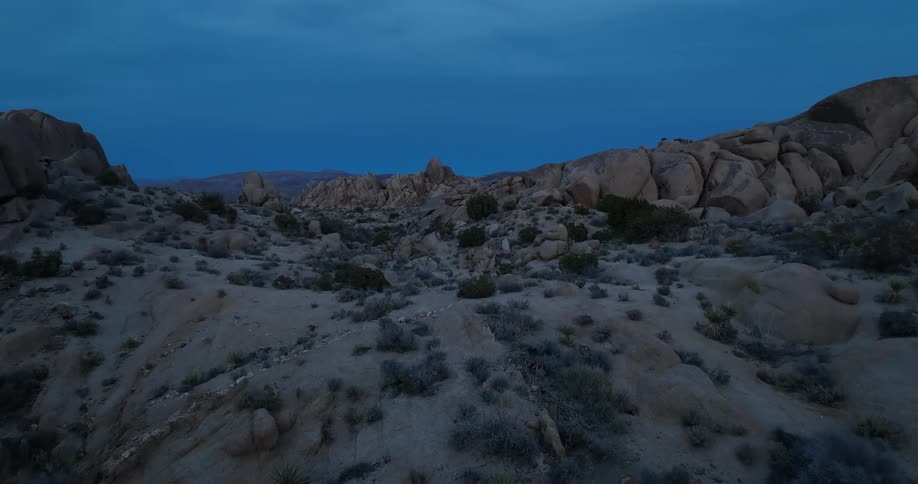 Aerial view of rugged and rocky hill at dusk