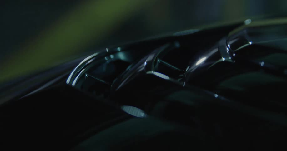 Close up of the details on the hood of a luxury vehicle at night