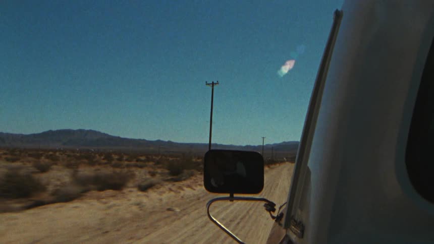 A car moving through a lonely sandy place and creating a sense of adventure isolation and exploration