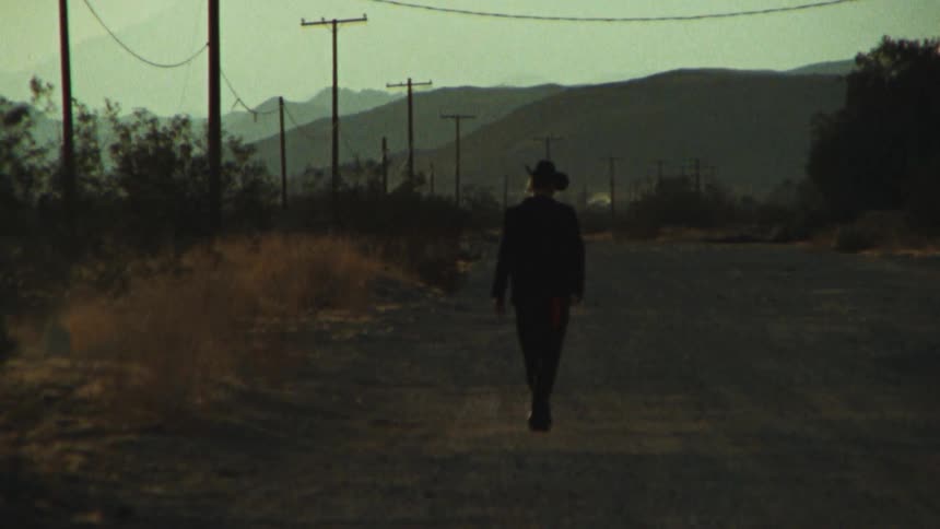 A person is walking down the road