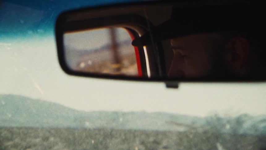 A man is driving on a foggy day