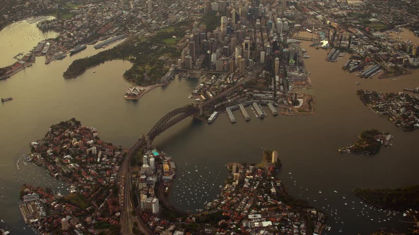 Aerial view of a downtown city near an ocean is dsiplayed