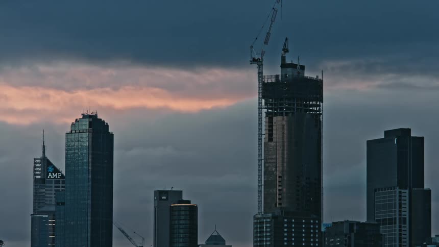 Some metallic looking buildings are shown against a sky