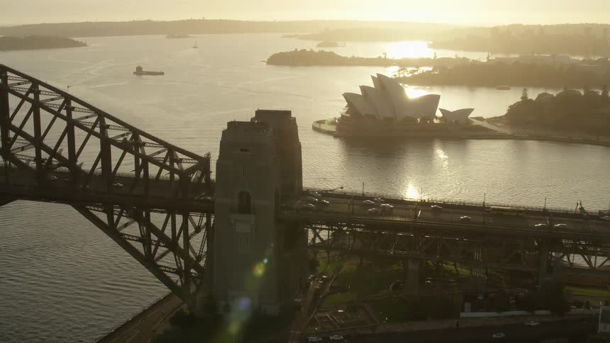 Aerial view of the sun setting above the city skyline
