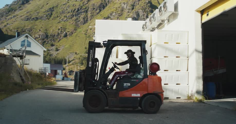 An industrial machine vehicle driving out of the gate is a common scene in manufacturing and production facilities