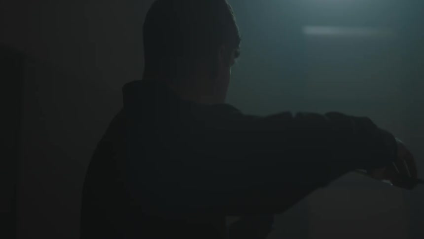 A person is playing an instrument in the dark