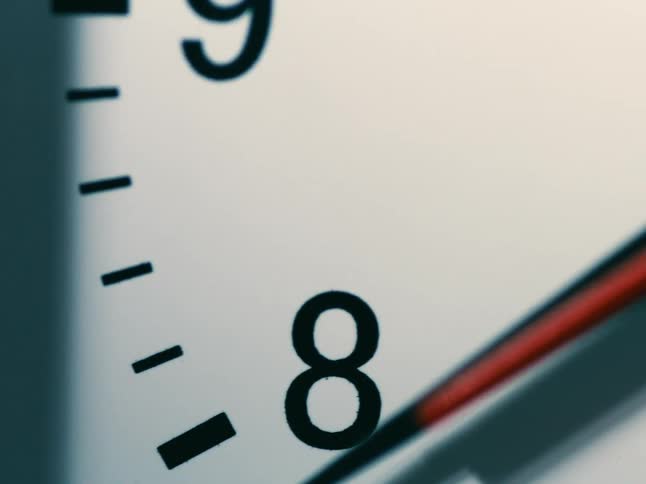 Second hand moves past the 8 on analog wall clock