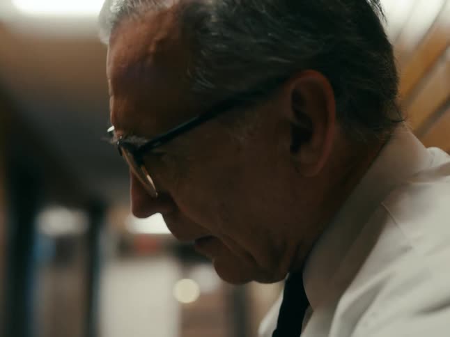 A man looks around in the hallway