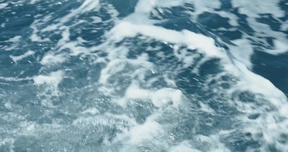 Waves splash and foam as they roll into shore