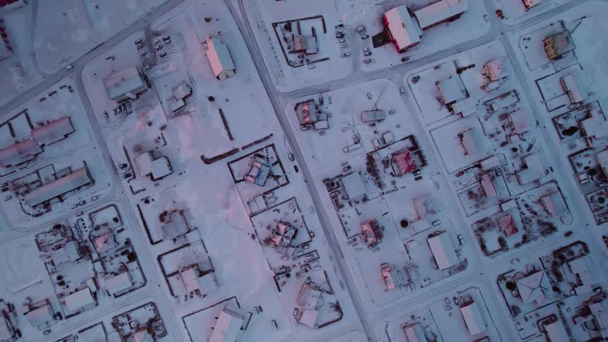 Aerial view of suburban area with light cover of snow during the day